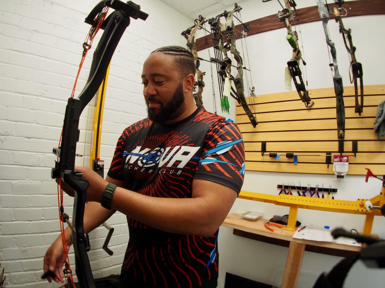 Nova’s ATA Certified Bow Tech setting up a compound bow on the press