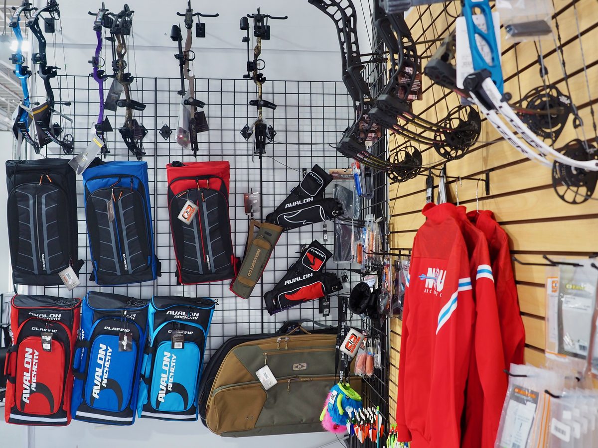 Bows, cases, and Nova apparel on the pro shop wall