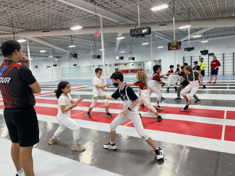 Youth Saber doing fencing drills in our Metro DC location