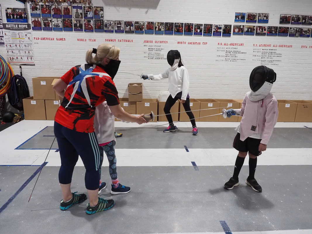 Fencing Coach with a camper